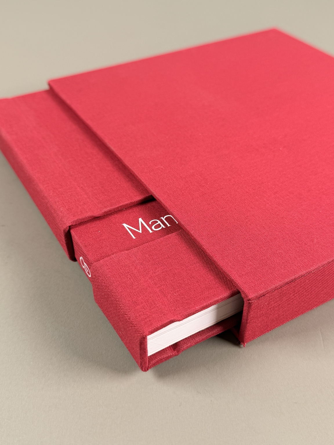 Red album inside its matching fabric slipcase