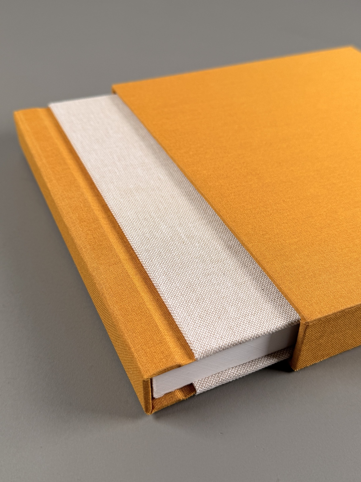 Ivory album with saffron spine and coordinating slipcase