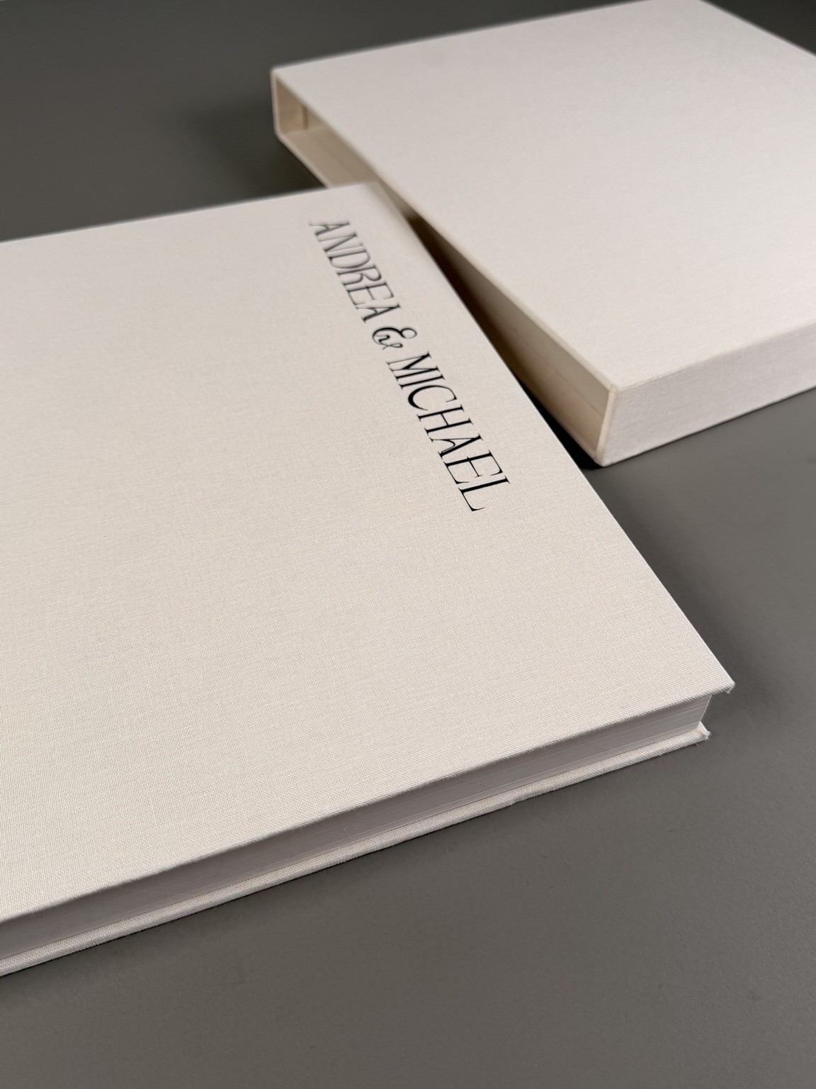 Diagonal detail of an ivory personalised album and coordinating slipcase