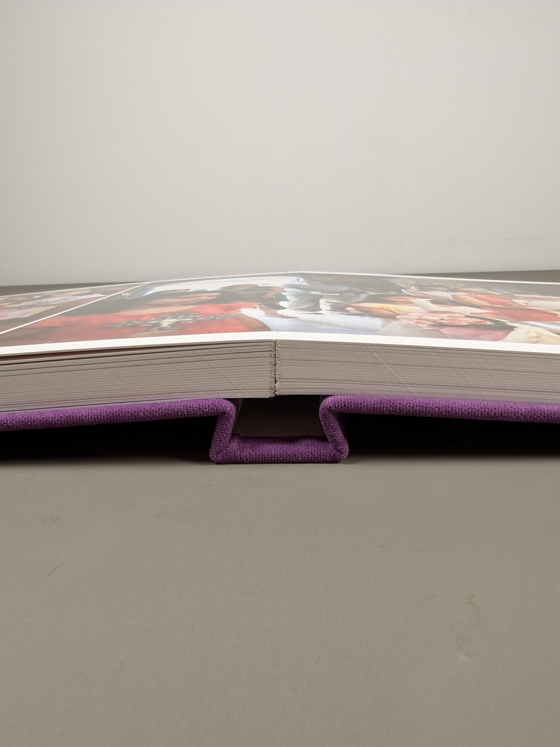 Open handmade album showing its lay-flat binding and substantial pages